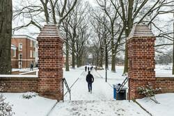 Students walking down Willow Walk in the snow.