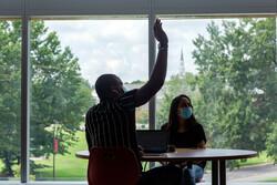 Students wearing masks in the classroom in the Brendan Iribe Center, with 4Maryland signage.