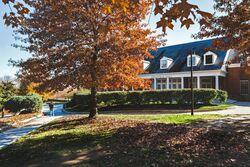 View of Annapolis Hall dormitory surrounded by fall foliage, home to the Department of Resident Life.